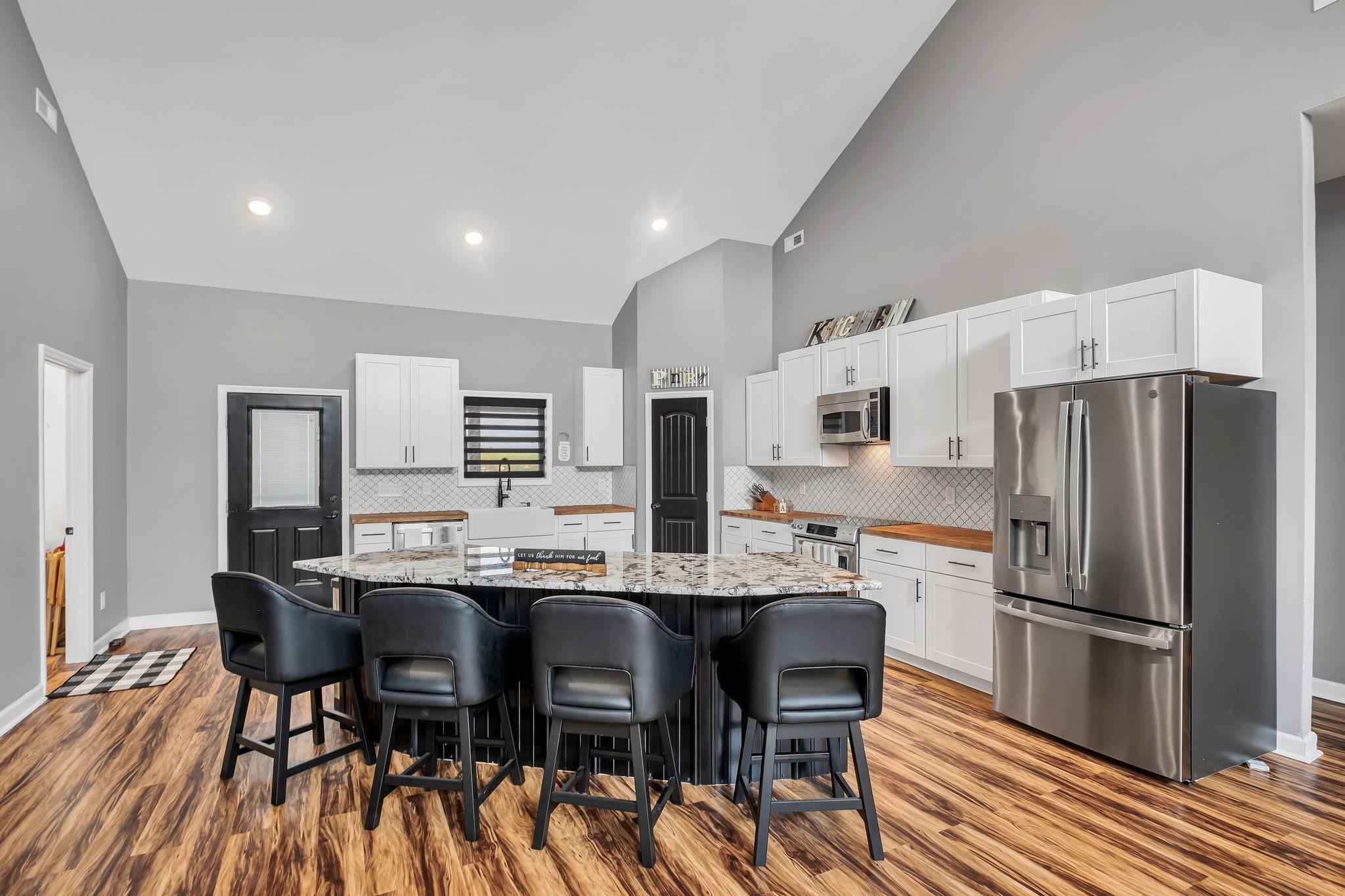 310 Christopher Lane Lawrenceburg, TN 38464 - Photo 9 of 50 a kitchen with stainless steel appliances a dining table chairs refrigerator and sink