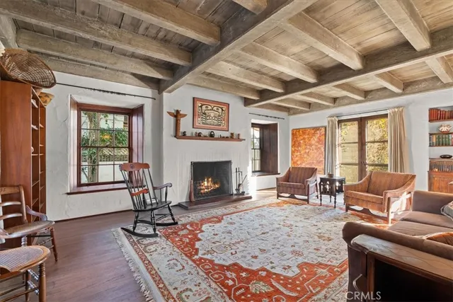 a living room with furniture windows and a fireplace