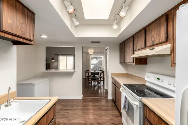 a kitchen with a sink stove and cabinets