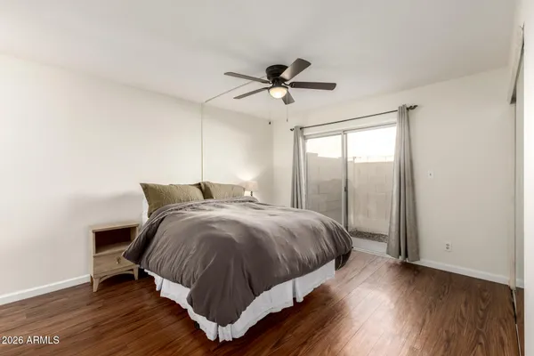 a bedroom with a bed and wooden floor