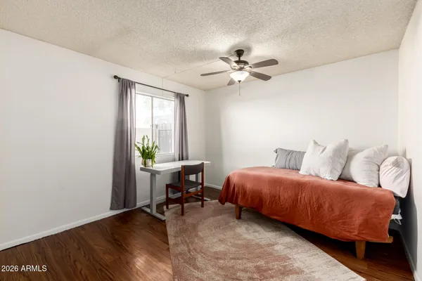 a living room with a bed furniture and a window