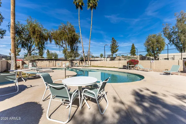 a view of a swimming pool with outdoor seating