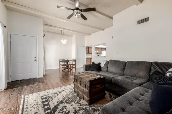 a living room with furniture and a wooden floor