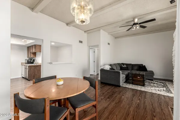 a living room with furniture and a chandelier