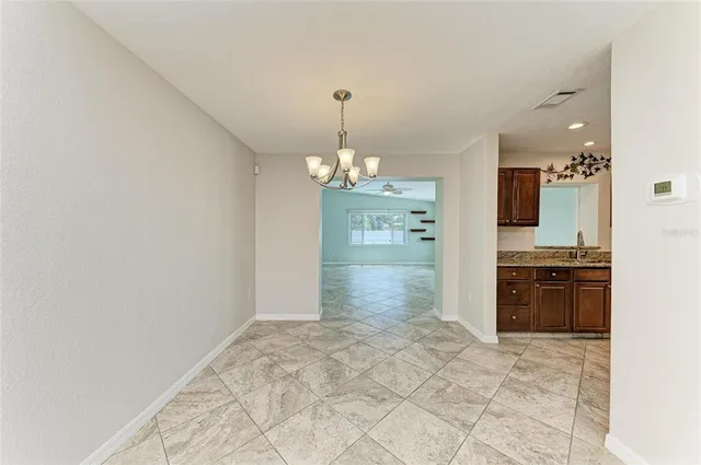 a spacious bathroom with a granite countertop sink a mirror and a shower