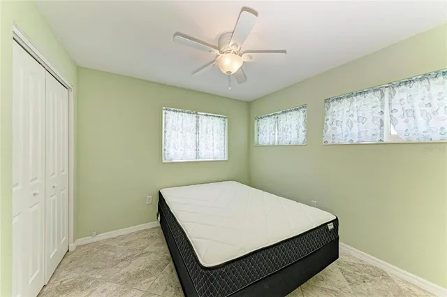 a room with a bed and white walls