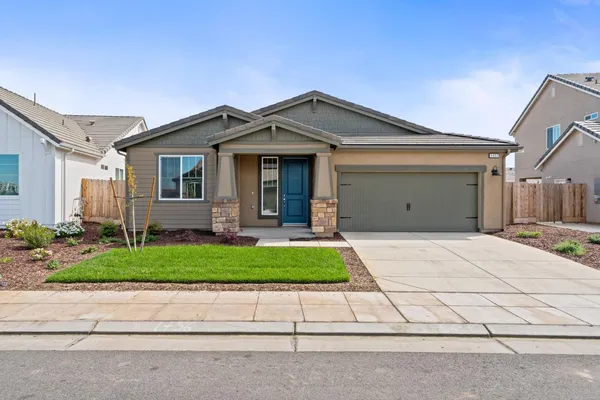 a view of a house with a yard and garage