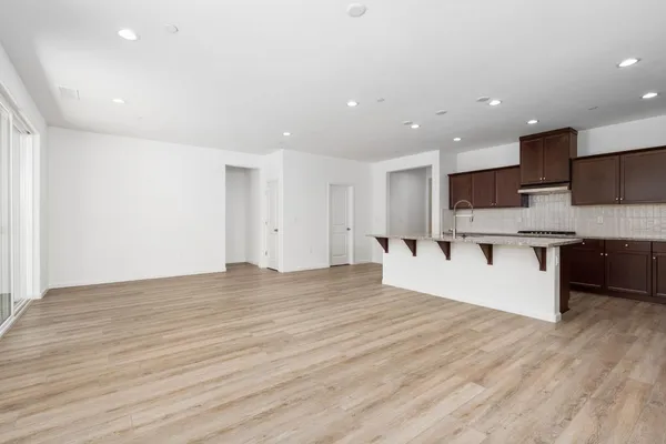 a view of kitchen with stainless steel appliances kitchen island a refrigerator sink and cabinets