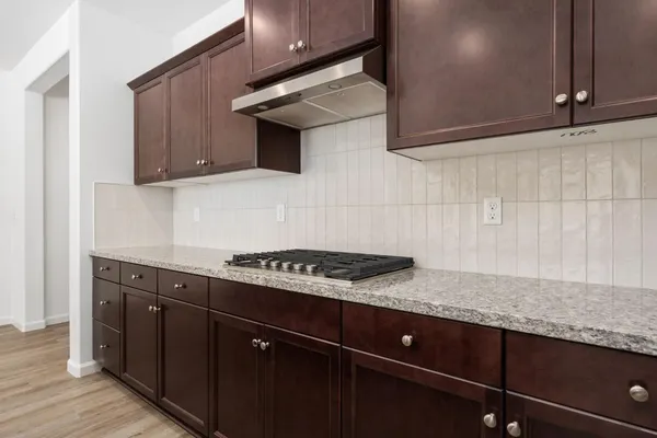 a kitchen with granite countertop stainless steel appliances a sink and cabinets