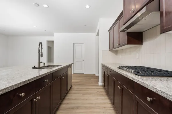 a kitchen with stainless steel appliances granite countertop a sink and stove