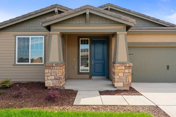 a front view of a house with a garden
