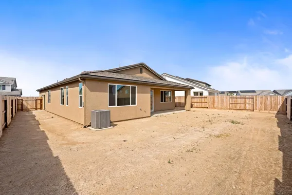 a view of a house with wooden fence