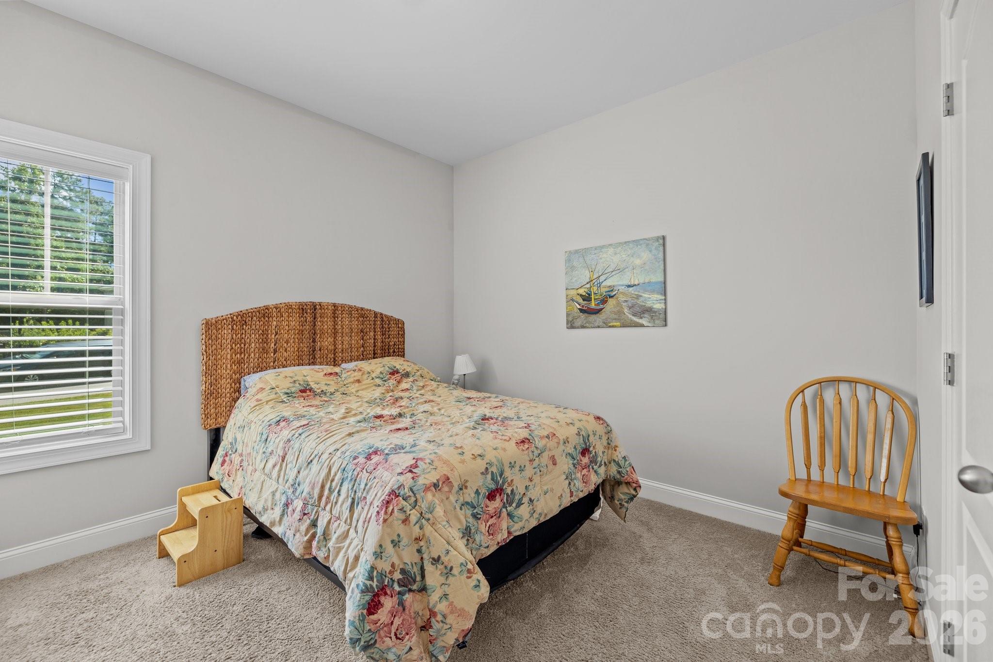 4697 Rinaldo Road York, SC 29745 - Photo 20 of 37 a bedroom with a bed a chair and a window
