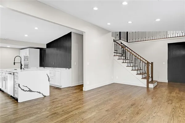 a view of entryway and hall with wooden floor