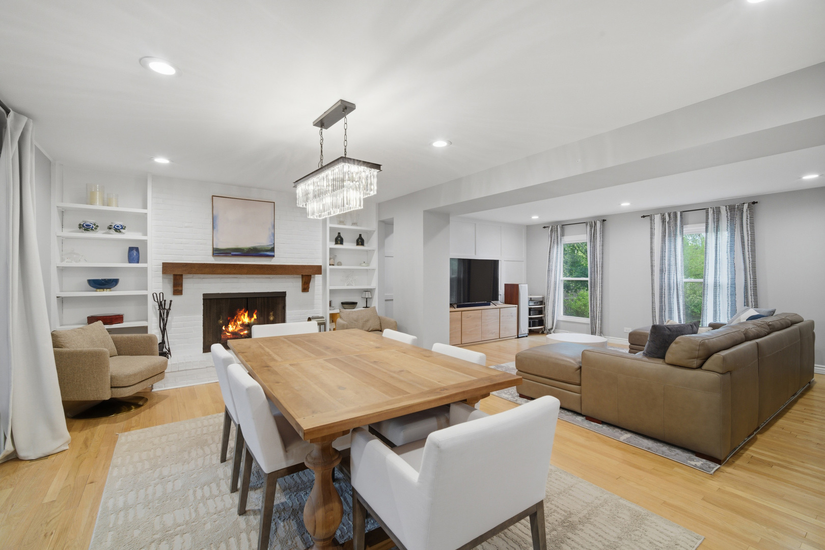 2831 Farmington Road Northbrook, IL 60062 - Photo 9 of 33 a living room with furniture a fireplace and a chandelier