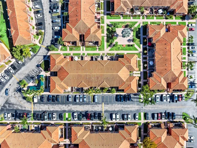 an aerial view of residential houses with outdoor space and river