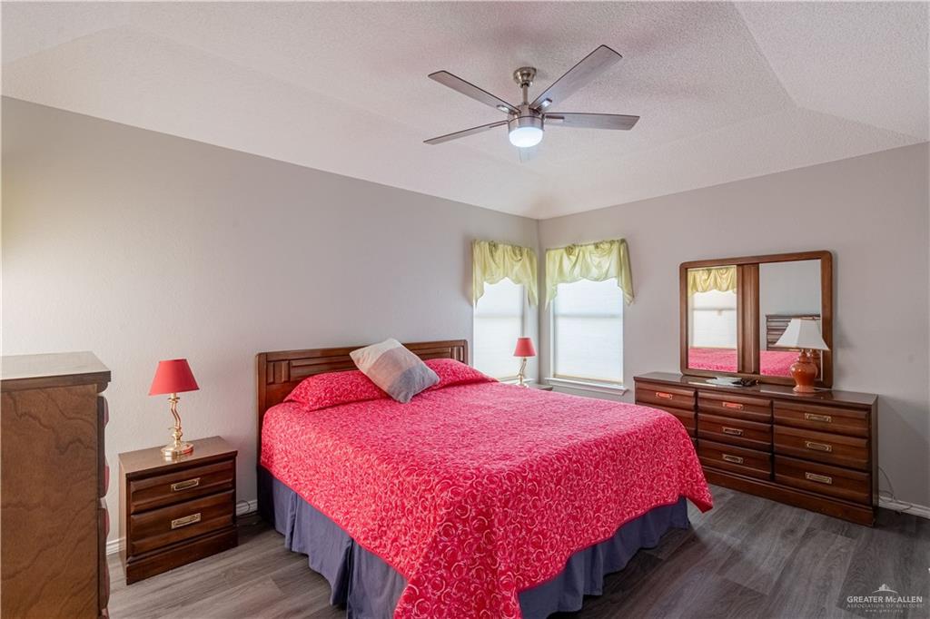100 West Moore Road, Unit UT39 Pharr, TX 78577 - Photo 9 of 21 Tray ceiling with a ceiling fan light fixture, wood-finish flooring, and two windows