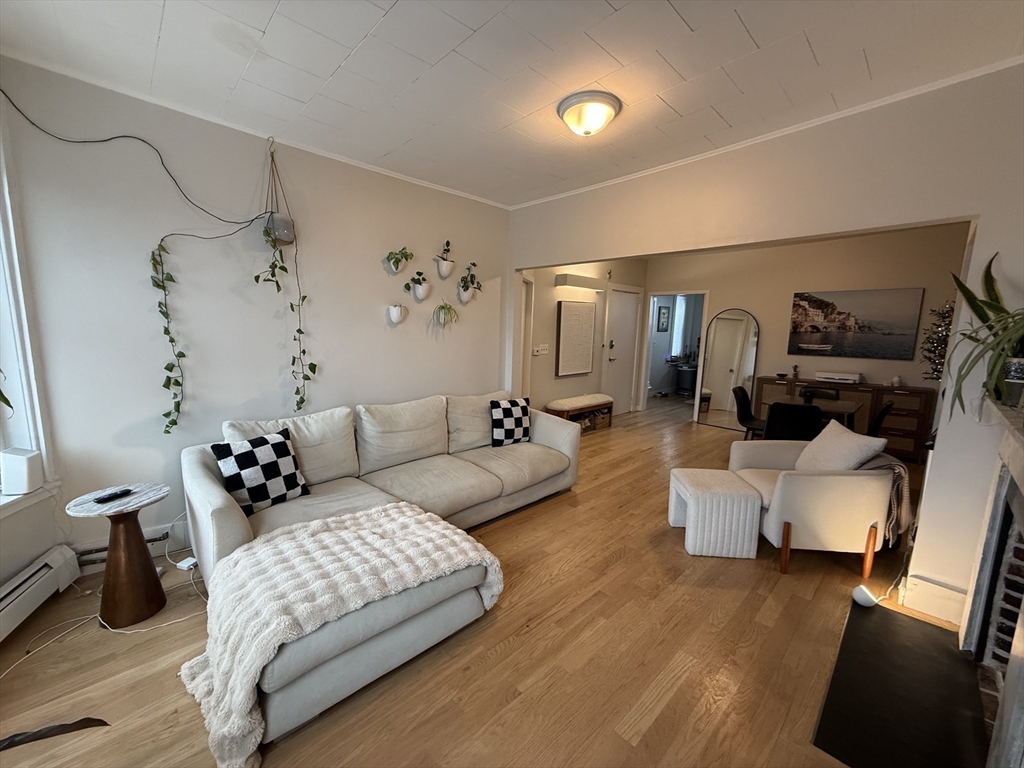 a bedroom with furniture and wooden floor