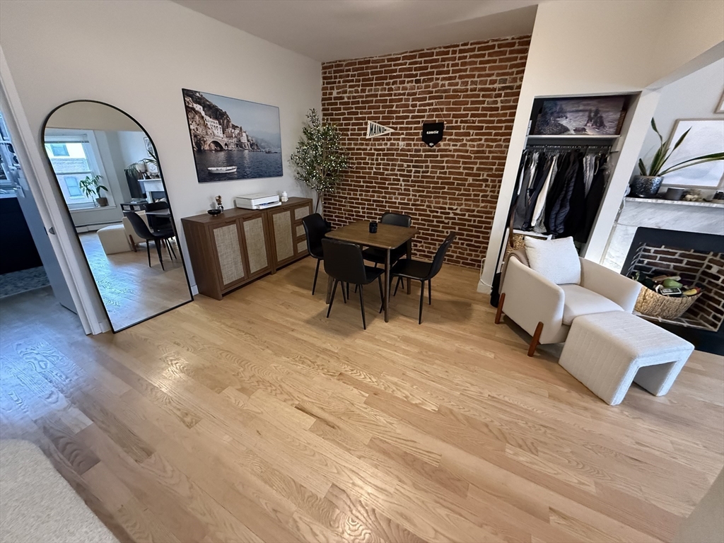 179 Webster Street, Unit 3 Boston, MA 02128 - Photo 3 of 13 a living room with furniture and wooden floor