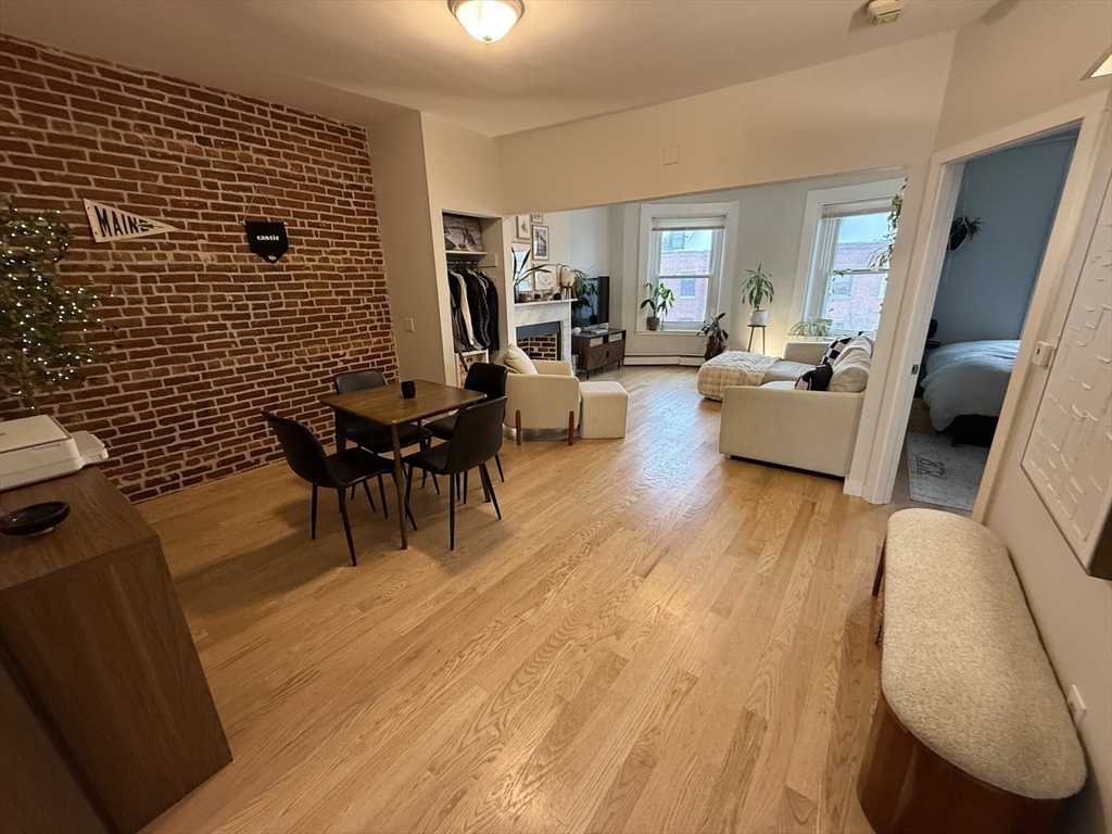 179 Webster Street, Unit 3 Boston, MA 02128 - Photo 4 of 13 a living room with furniture and a wooden floor