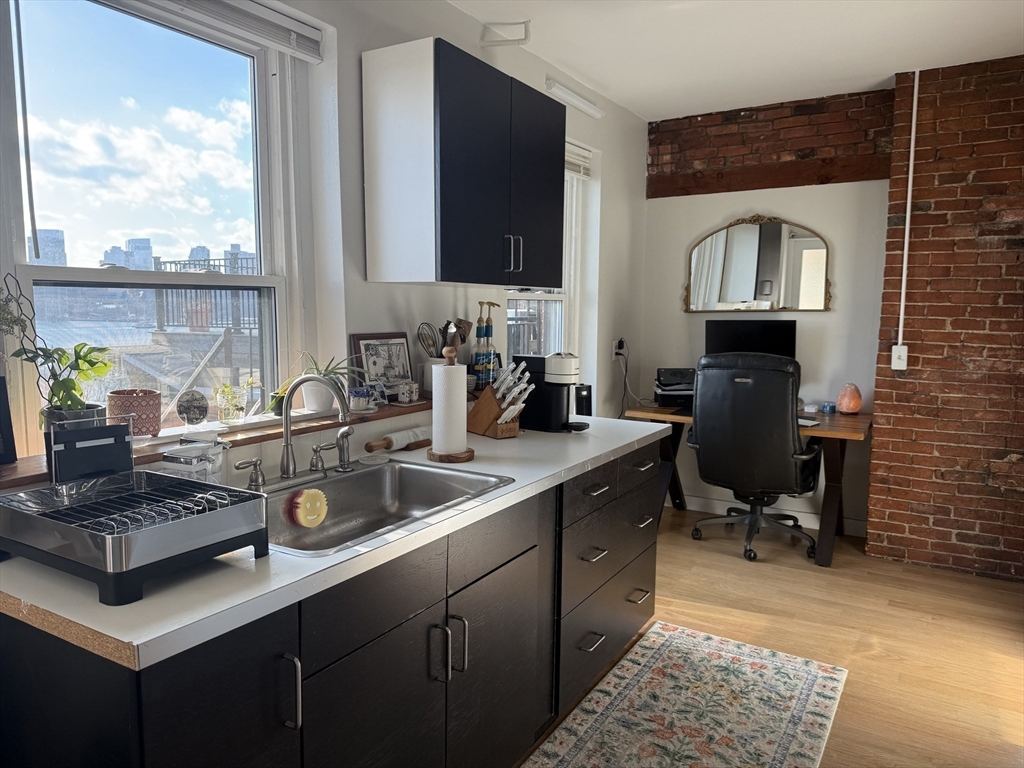 179 Webster Street, Unit 3 Boston, MA 02128 - Photo 5 of 13 a kitchen with a sink stove and cabinets