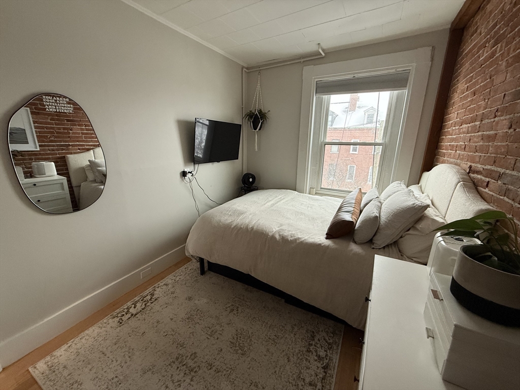179 Webster Street, Unit 3 Boston, MA 02128 - Photo 7 of 13 a bedroom with a bed and window