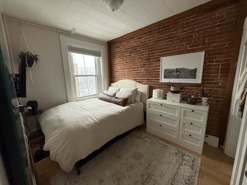 179 Webster Street, Unit 3 Boston, MA 02128 - Photo 8 of 13 a bedroom with a bed and a dresser