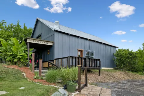 a view of a house with backyard and sitting area
