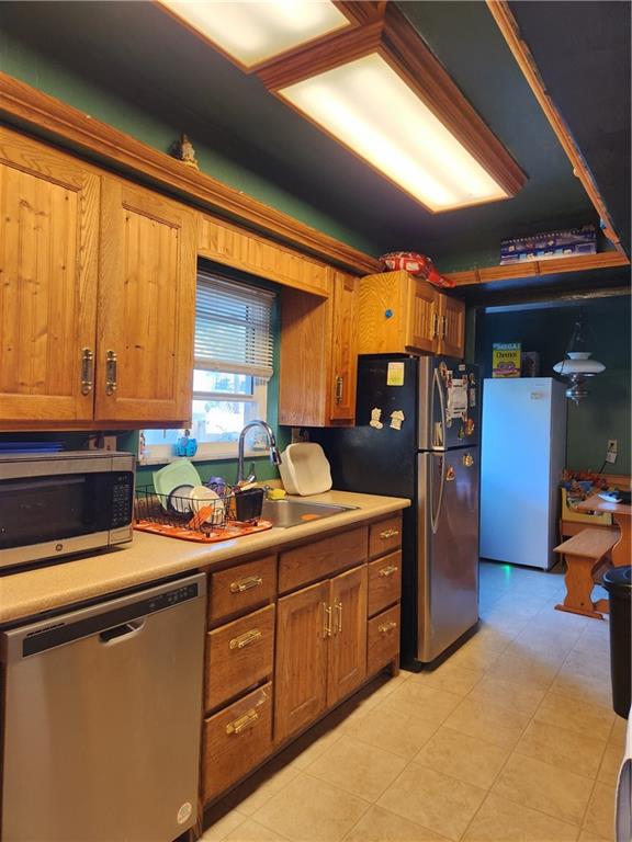 302 South Second Street Apollo, PA 15613 - Photo 9 of 15 a kitchen with stainless steel appliances granite countertop a sink dishwasher stove and refrigerator with wooden floor