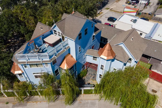 an aerial view of multiple houses with yard