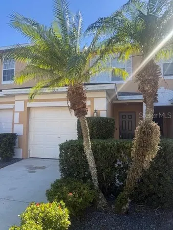 a view of a house with a tree and a yard