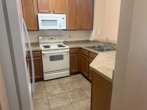 a utility room with sink washer and dryer
