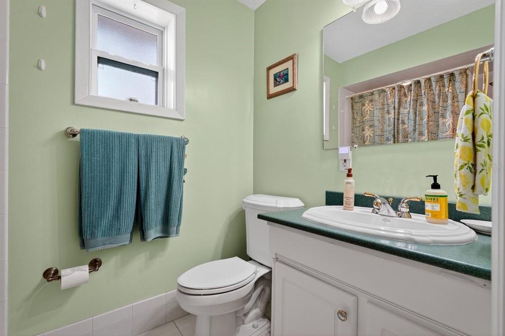 119 Carriage Ponce Inlet, FL 32127 - Photo 19 of 67 a bathroom with a granite countertop sink a mirror and a toilet