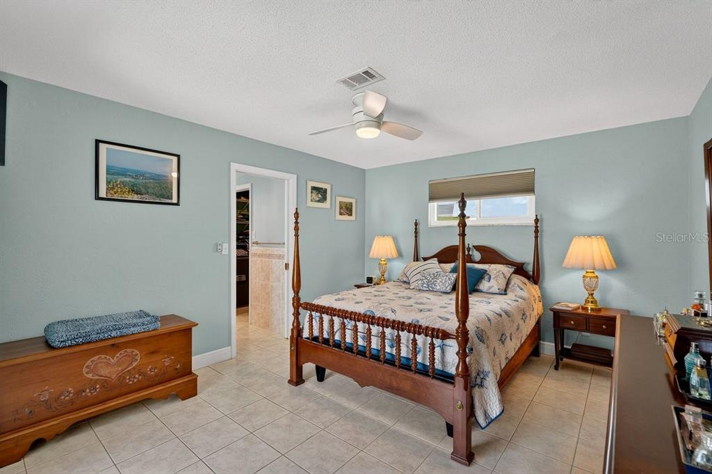 119 Carriage Ponce Inlet, FL 32127 - Photo 25 of 67 a bedroom with a bed and a chandelier