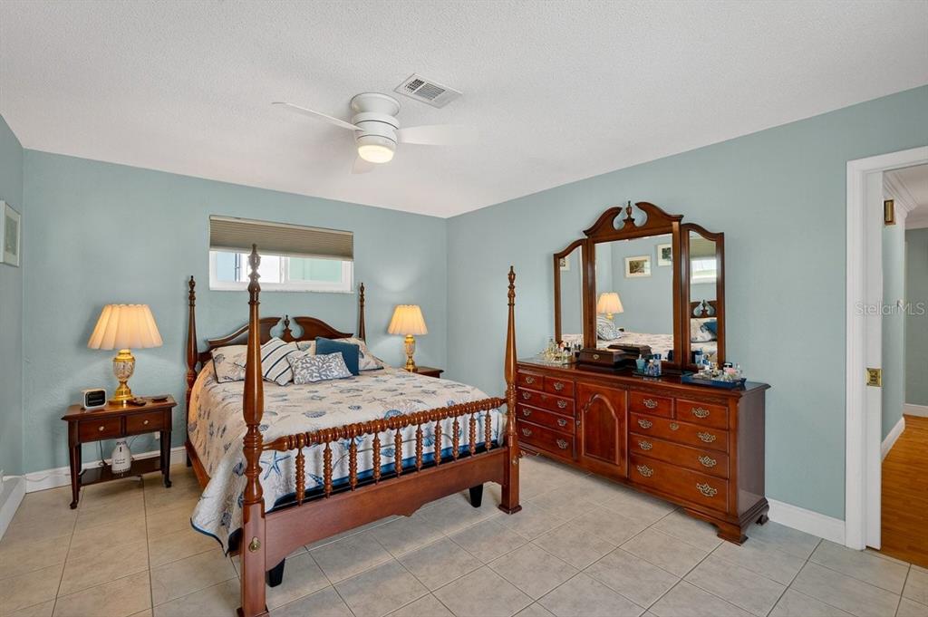 119 Carriage Ponce Inlet, FL 32127 - Photo 26 of 67 a bedroom with a bed and a chandelier
