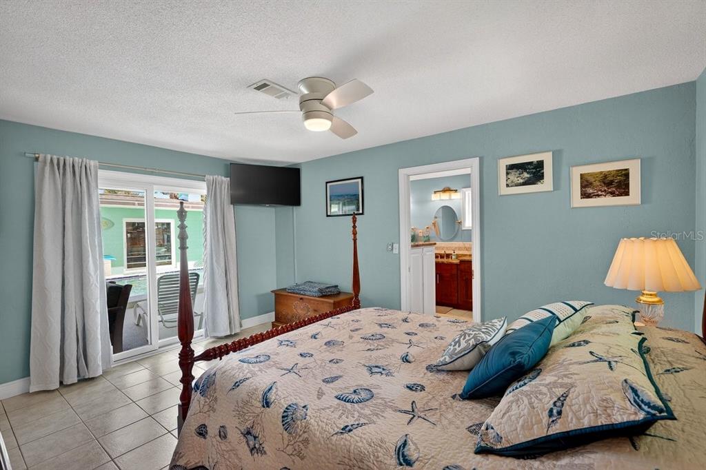 119 Carriage Ponce Inlet, FL 32127 - Photo 27 of 67 a bedroom with a large bed and a chandelier