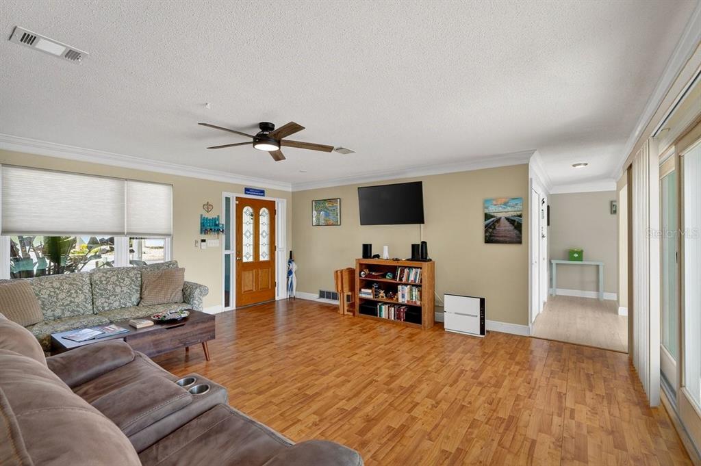 119 Carriage Ponce Inlet, FL 32127 - Photo 5 of 67 a living room with furniture and a flat screen tv with wooden floor