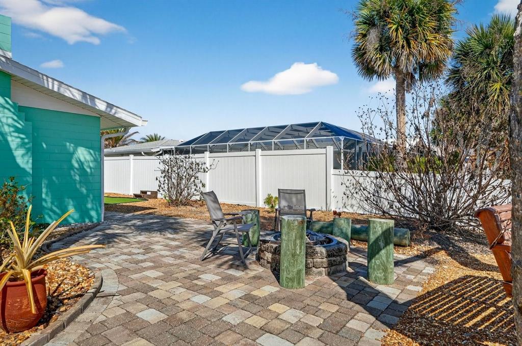 119 Carriage Ponce Inlet, FL 32127 - Photo 62 of 67 a view of a patio with table and chairs and potted plants