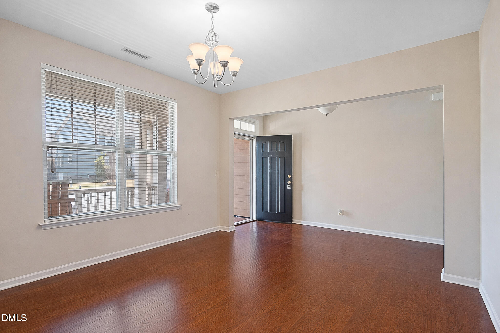 4249 Saubranch Hill Street Raleigh, NC 27616 - Photo 7 of 31 a view of an empty room with wooden floor and a window