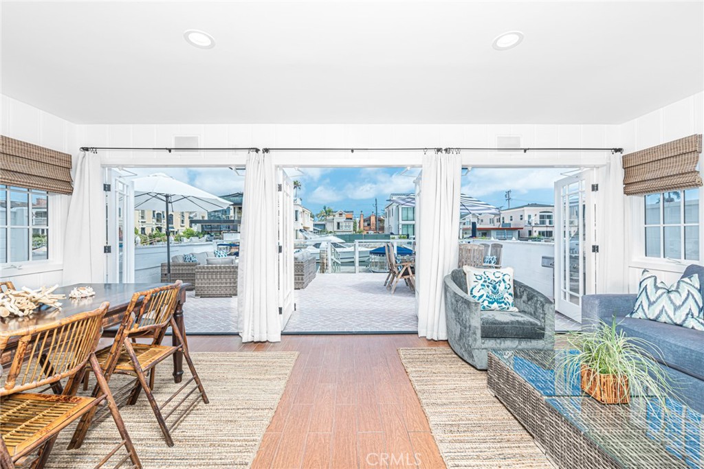 3717 Channel Place Newport Beach, CA 92663 - Photo 12 of 41 a living room with furniture and a floor to ceiling window