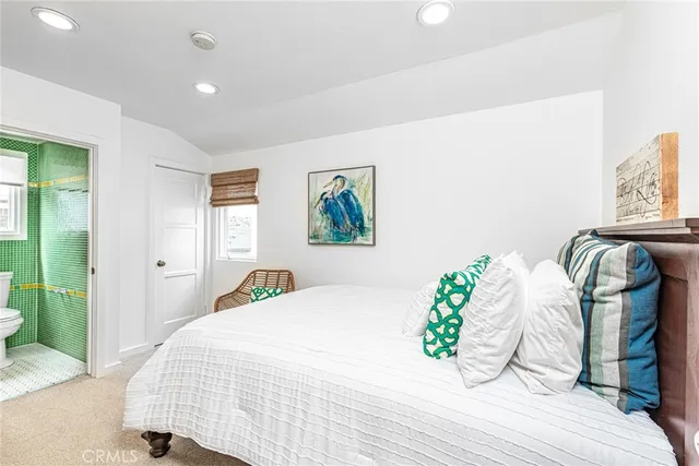 a bedroom with a bed and painting on the wall