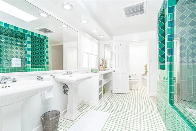 a large white kitchen with a sink and a large window