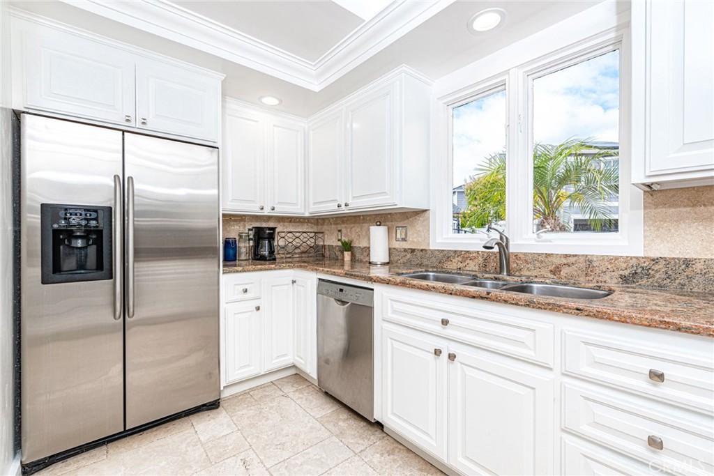 3717 Channel Place Newport Beach, CA 92663 - Photo 21 of 41 a kitchen with granite countertop stainless steel appliances a refrigerator sink and cabinets