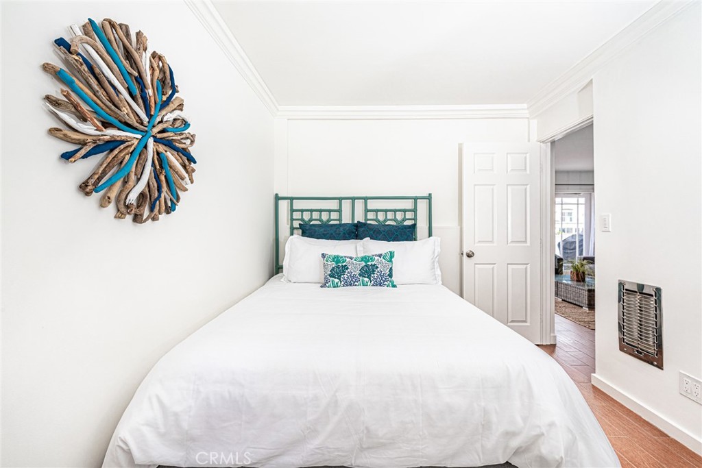 3717 Channel Place Newport Beach, CA 92663 - Photo 22 of 41 a spacious bedroom with a bed and a painting on the wall