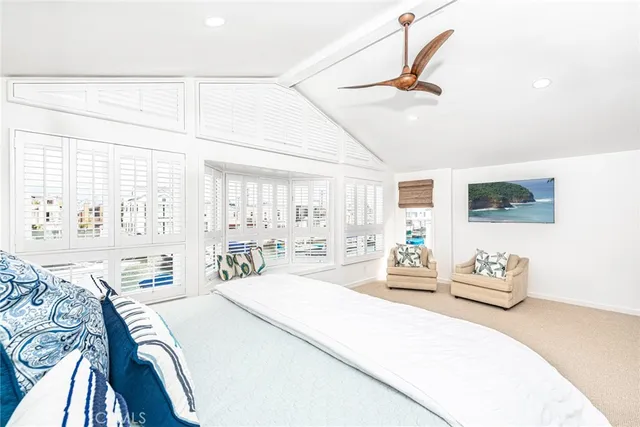 a bedroom with furniture and a large window