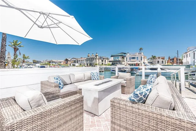 a view of a patio with couches and umbrella