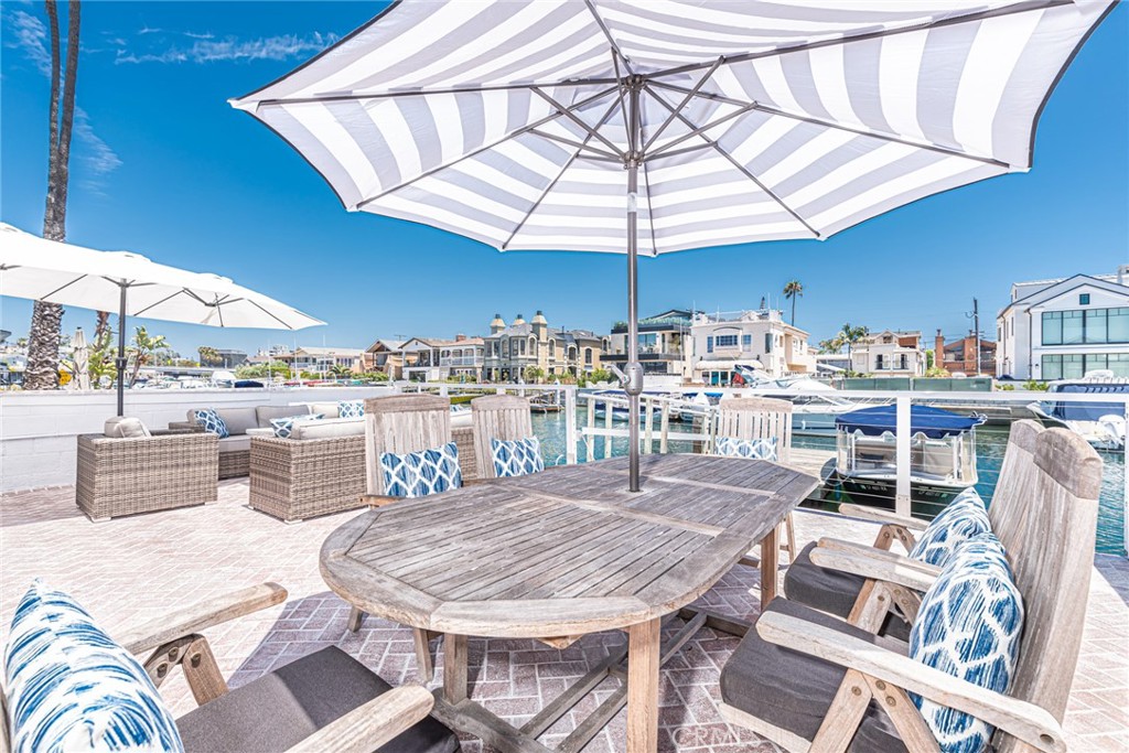 3717 Channel Place Newport Beach, CA 92663 - Photo 8 of 41 a table and chairs under an umbrella