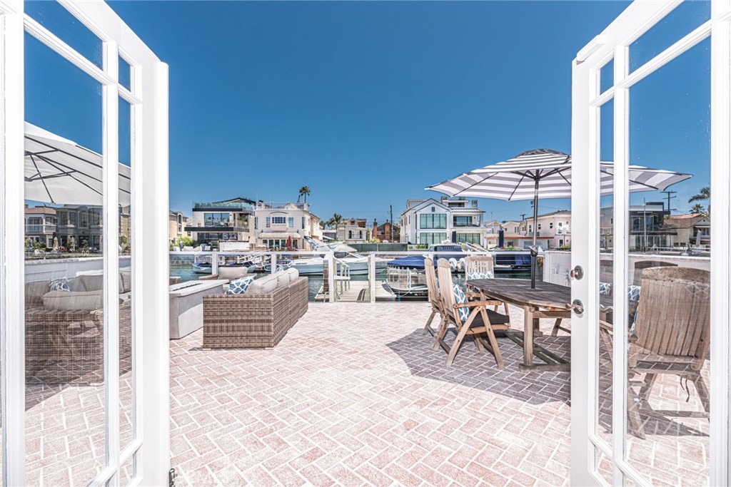 3717 Channel Place Newport Beach, CA 92663 - Photo 9 of 41 a view of a patio with a table and chairs and potted plants