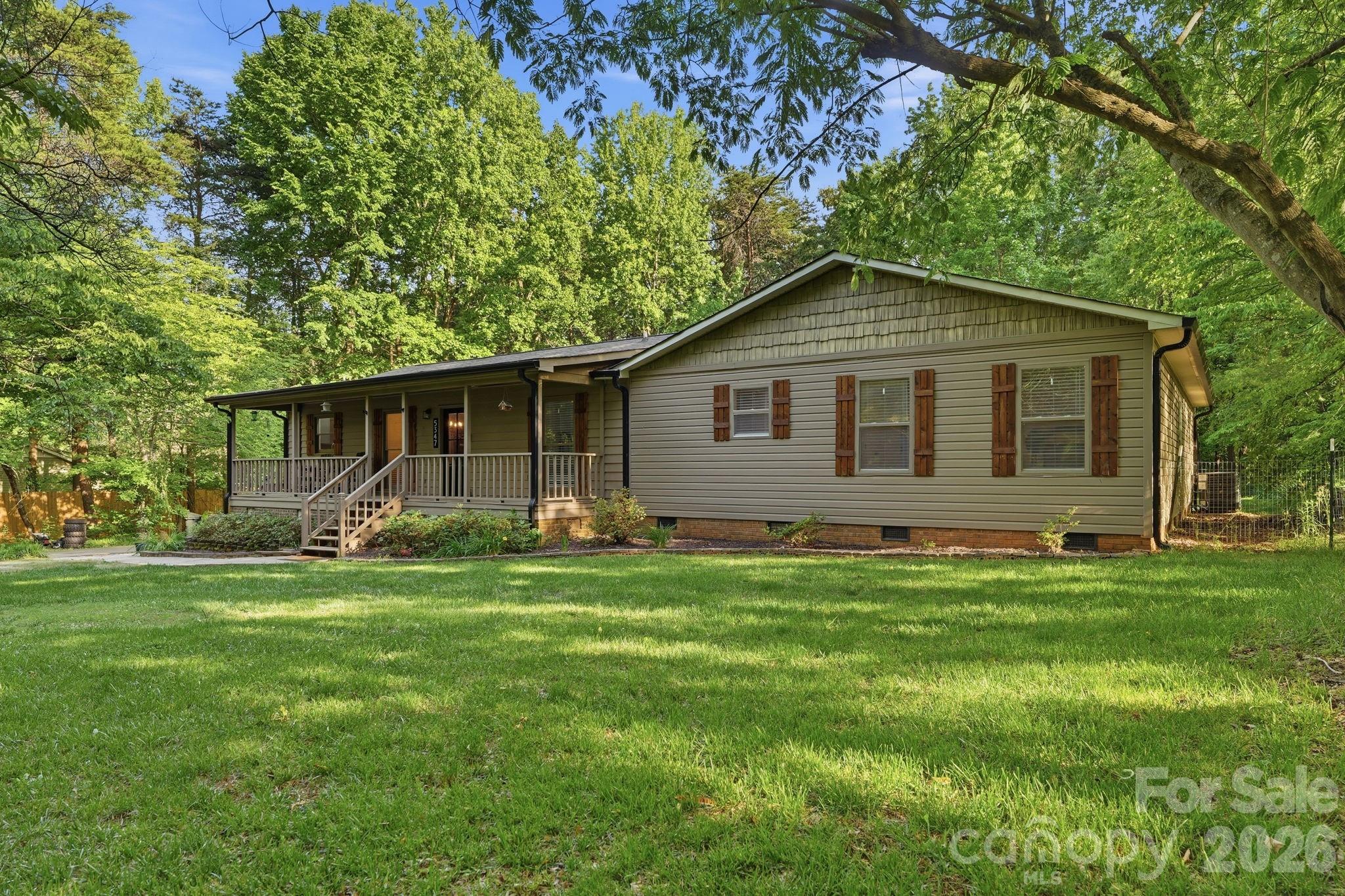 a front view of house with yard and green space