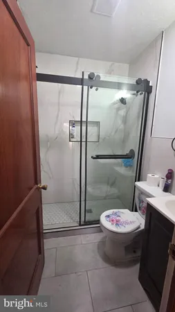 a bathroom with a toilet and a shower